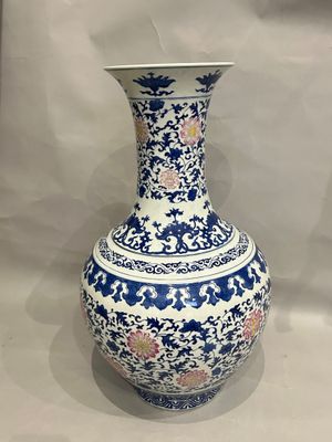 a blue and white vase sitting on a table