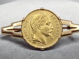 l'image d'un anneau d'or surmonté d'une pièce de monnaie