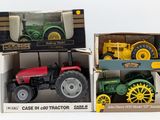 two toy tractors in a box on a white surface