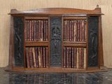 a wooden book shelf with a lot of books on it