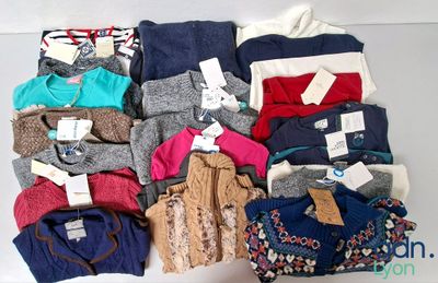 a lot of clothes that are sitting on a table