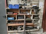 a wooden shelf with tools on it in a garage