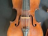a violin and a violin case on a table