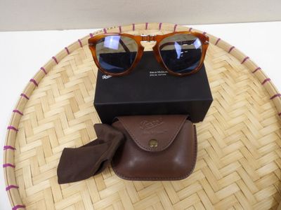 a pair of sunglasses sitting on top of a basket