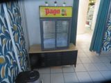 a picture of a refrigerator in a room with a blue curtain