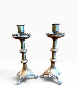 pair of antique silver candlesticks on cast iron bases