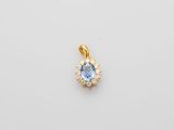 a blue topaz stone and diamond pendant on a white background