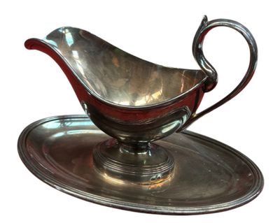 a silver gravy on a silver plate on a white background
