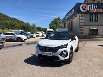 a white car parked in front of a building with cars parked in front of it