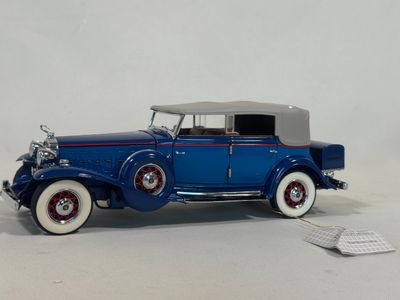 a toy car that is sitting on a white surface