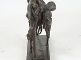 statue of a man riding a horse with a woman on his back