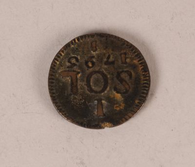 gros plan d'une pièce de monnaie sur une surface blanche