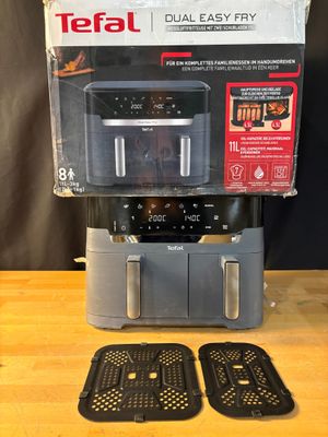 a close up of a coffee maker on a wooden table