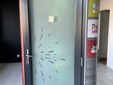 a glass door with a clock on it in a room