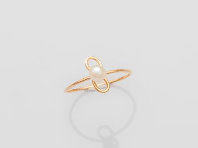 a gold ring with a pearl in the middle