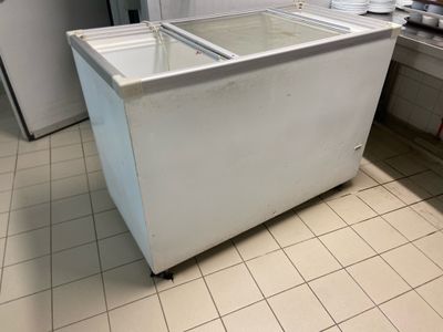 an image of a kitchen with a refrigerator and a freezer