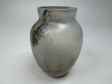 a silver vase sitting on a table with a white background