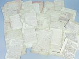 many old papers are piled on top of each other on a blue surface