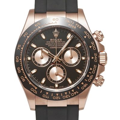 a close up of a watch on a white background with a rose gold dial