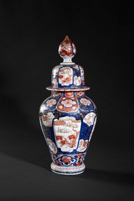 a close up of a vase on a black surface with a black background