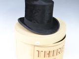 a black top hat sitting on top of a white box