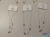 several different types of necklaces are displayed on a white surface