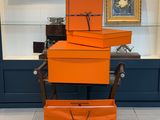 three orange boxes stacked on top of each other in front of a window