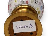 a white and gold vase with a label on it