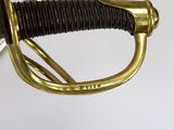 a close up of a sword with a gold handle