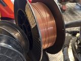 a spool of copper wire on a table
