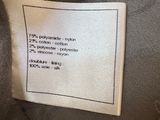 a close up of a label on the back of a jacket