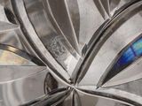 a close up of a metal object with a blue and yellow design on it