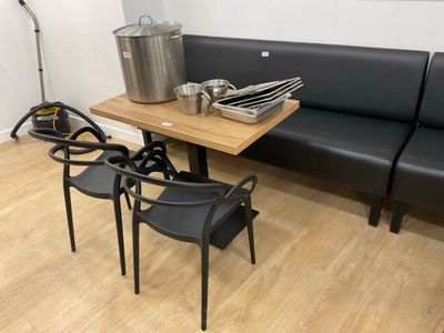 a table with chairs and pots on it in the corner of a room