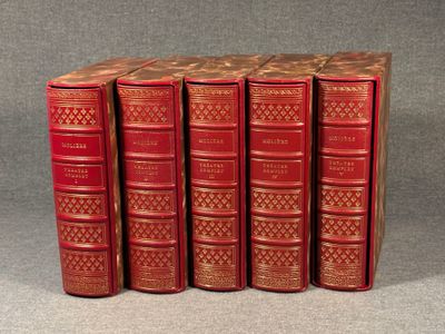 four red books are stacked on top of each other on a gray surface