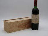 une bouteille de vin posée à côté d'une caisse en bois