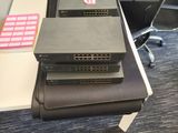 several laptops are stacked on top of each other on a desk
