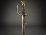 an old sword with a gold handle on a black background