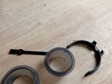 a pair of glasses sitting on the floor next to a pair of scissors