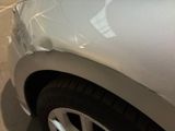 a close up of a car with a denting on the front of it