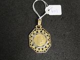 a close up of a gold medal on a black surface with a price tag