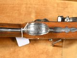 an old rifle with a wooden handle and a metal handle