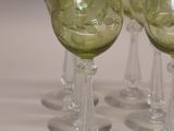 four wine glasses sitting on a table next to a dice