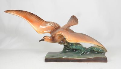 a figurine of a bird that is sitting on a table