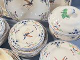 a lot of plates and bowls that are sitting on a table