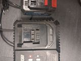 two batteries and a charger on a table