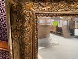 a mirror that is sitting on the floor in a room