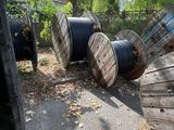 a lot of old wooden spools sitting on the ground