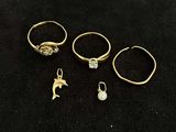 three gold rings and a ring with a dolphin on it
