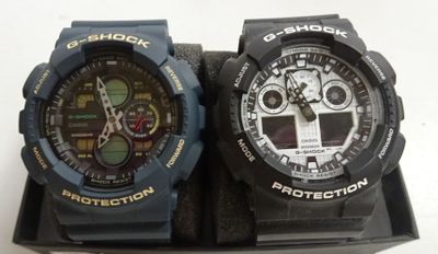 two watches that are sitting on top of a box