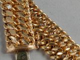an image of a gold chain bracelet with a usb drive attached to it